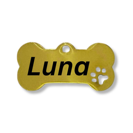 A gold-colored stainless steel dog name tag in the shape of a bone with the name 'Luna' engraved on it.