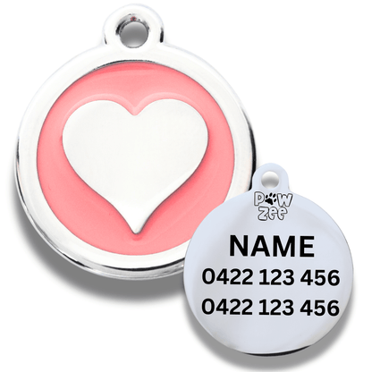 Pet tag with pink heart design and engraved text on a white background